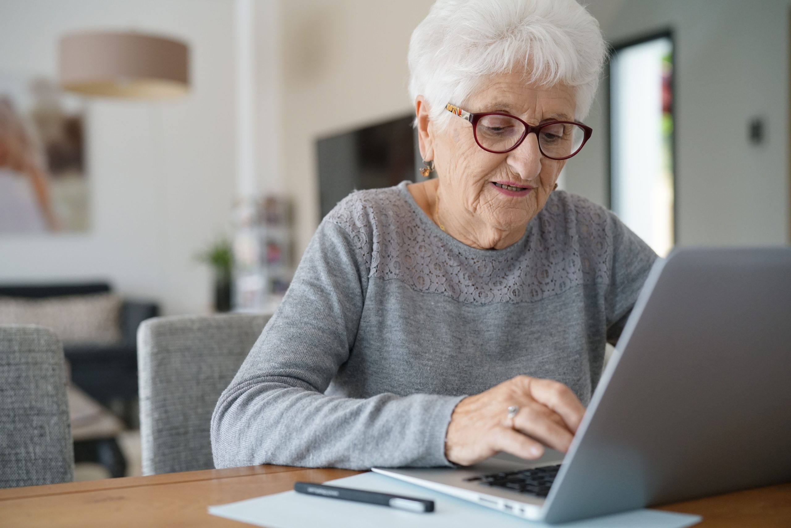 Senior woman at home using laptop computer